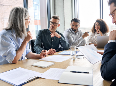 People sitting around a large table in an office